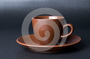 Clay (ceramic) cup on dark