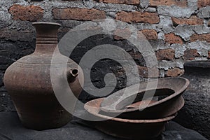 Clay crafts lined against a brick wall backdrop