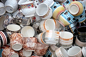 Clay cups randomly arranged for sale