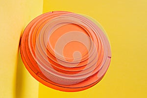 Clay disc target for skeet shooting flying against the colorful yellow background