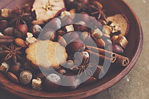 Clay display with gingerbread cookies, spices, nuts and brown sugar