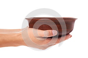 Clay empty brown bowl in hand isolated on white background