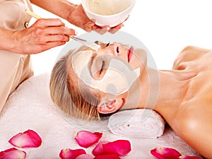 Clay facial mask in beauty spa. photo