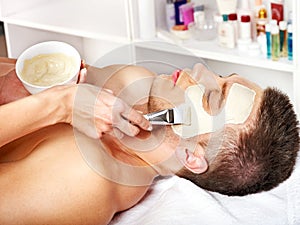 Clay facial mask in beauty spa.