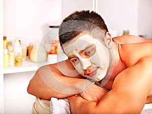 Clay facial mask in beauty spa.