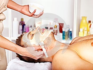 Clay facial mask in beauty spa.