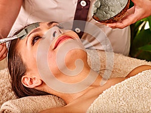 Clay facial mask in beauty spa