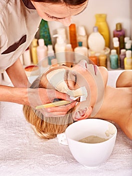 Clay facial mask in beauty spa