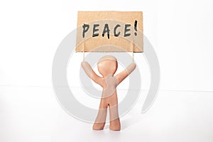 clay figure holding peace banner