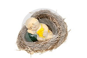 Clay figurine in bird nest