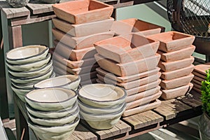 Clay flower pots stucked on wooden table in the garden