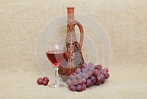 Clay Georgian bottle, glass and grapes