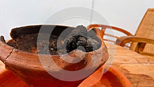 The clay incense burner on the table is ready to be used for rituals.