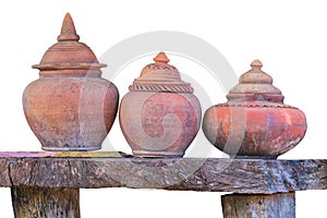 Clay jar on wood table isolated on white background. Clipping path