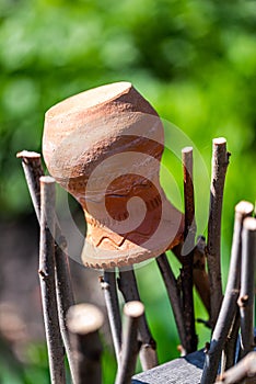 Clay jug on the old fence