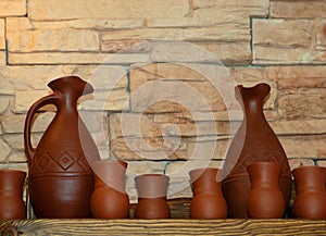 Clay jugs and cups on a shelf