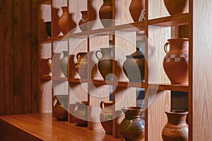 Clay jugs, old ceramic vases on a shelf. Beautiful hand made jugs. Ukrainian style, Ukraine concept