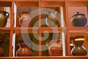 Clay jugs, old ceramic vases on a shelf. Beautiful hand made jugs. Ukrainian style, Ukraine concept