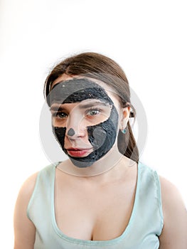 Clay mask purifying mud facial treatment for women. Black clay cosmetic mask for the face.