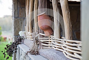 Clay pitcher/ Earthen jar on the wooden fence