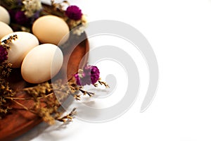 Clay plate with dry flowers on a white background, isolate