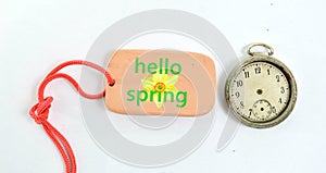 clay plate and vintage clock with text hellow spring