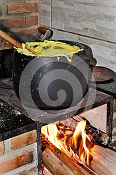 Clay pot with angu mineiro cooking in the wood oven