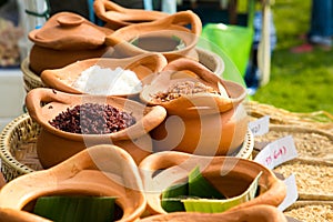 Clay pot filled with white rice, red rice and riceberry