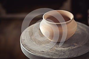 Clay pot on a potter`s wheel