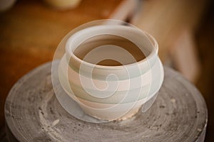 Clay pot on a potter`s wheel