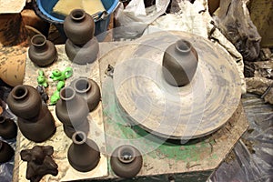 Clay pot on a potter`s wheel close-up