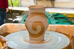 Clay pot on a pottery wheel