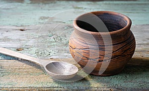 Clay pot and wooden spoon