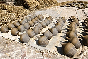 Clay pots (jars) drying in the sun on pottery square in Bhaktapur in Nepal