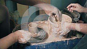Clay potter hands wheel pottery work workshop teacher and girl pupil 4k