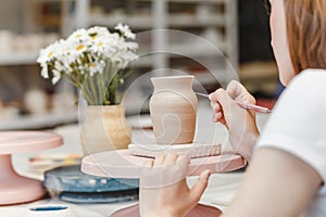 Clay pottery ceramic, woman decorating dishware pot