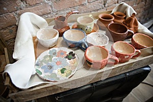 Clay products collection at workshop . Pottery workshop with crockery.