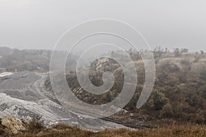 Clay quarry in the autumn fog