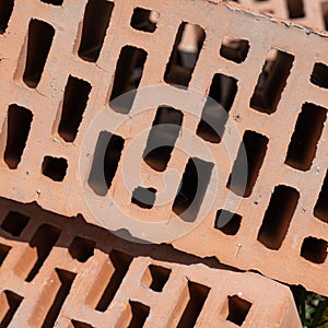 Clay red brick close-uo macro texture. Construction brick isolate on white