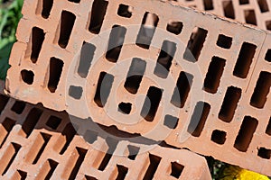 Clay red brick close-uo macro texture. Construction brick isolate on white