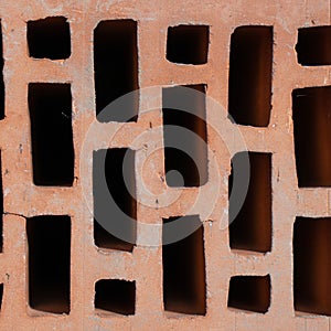 Clay red brick close-uo macro texture. Construction brick isolate on white