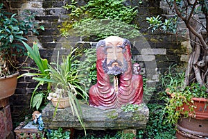 clay sculpture of an old man in the garden