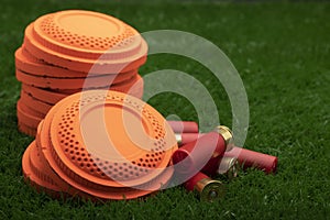 Clay shooting target and shotgun bullets on green background ,Clay Pigeon target game