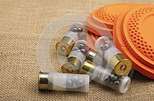 Clay shooting target with shotgun shell on sackcloth background , Clay pigeon shooting game