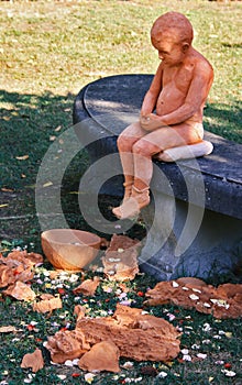 Clay statue of a boy sitting