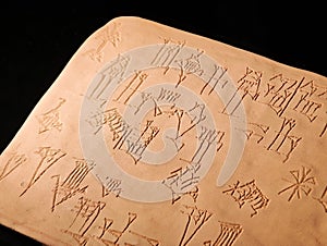 Clay tablet engraved with cuneiform script, ancient mesopotamian writing system artifact with sumerian and akkadian characters,