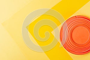 Clay target for skeet shooting against the colorful yellow background