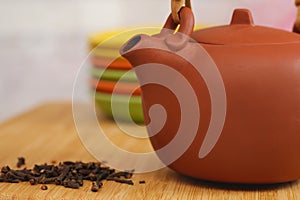 Clay teapot on color plates backgrounds