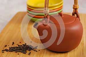 Clay teapot on color plates backgrounds