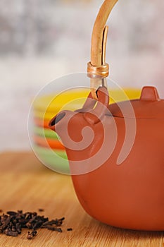 Clay teapot on color plates backgrounds